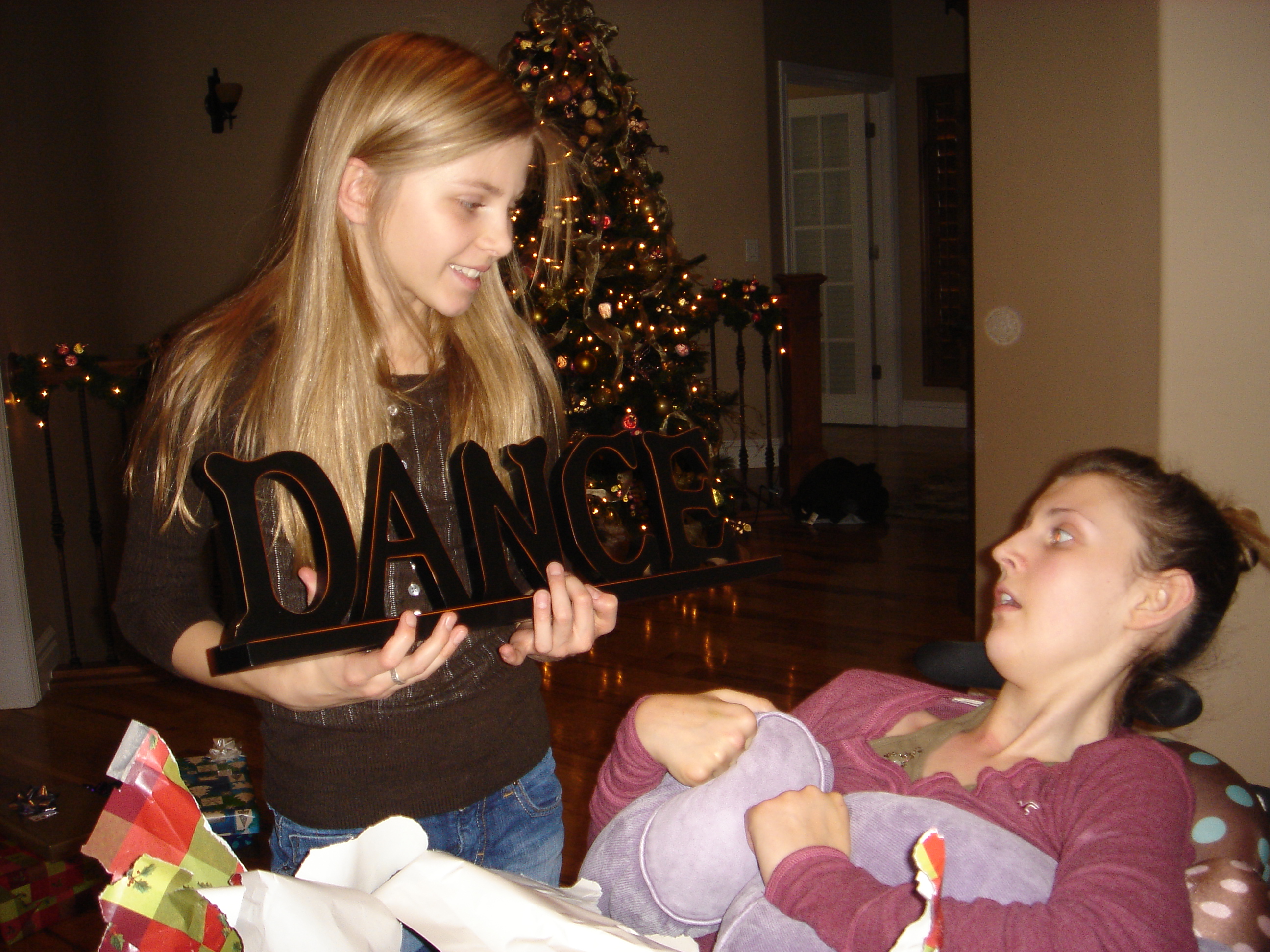 Whitney and Tori opening gifts on Christmas morning