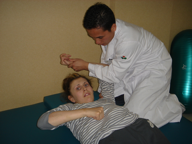 James in action massaging and stretching Tori's shoulder James in action massaging and stretching Tori's shoulder